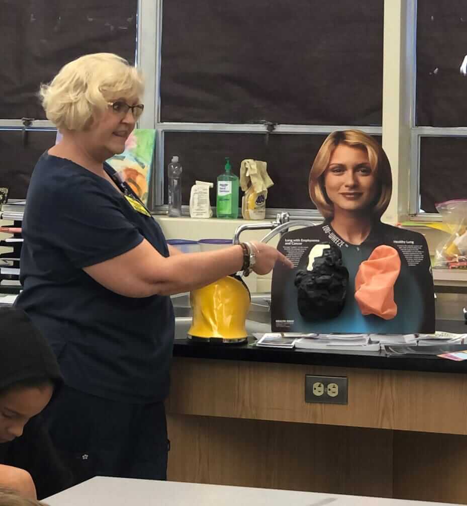 A woman teaching about lungs